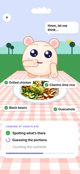 The pet looking at a photo of a chicken burrito bowl and spotting grilled chicken, cilantro-lime rice, black beans and guacamole.